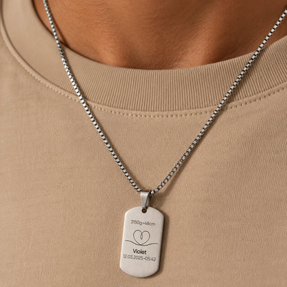 Silver personalised baby keepsake necklace worn on model, engraved with baby name Violet, birth weight, height, date and time.