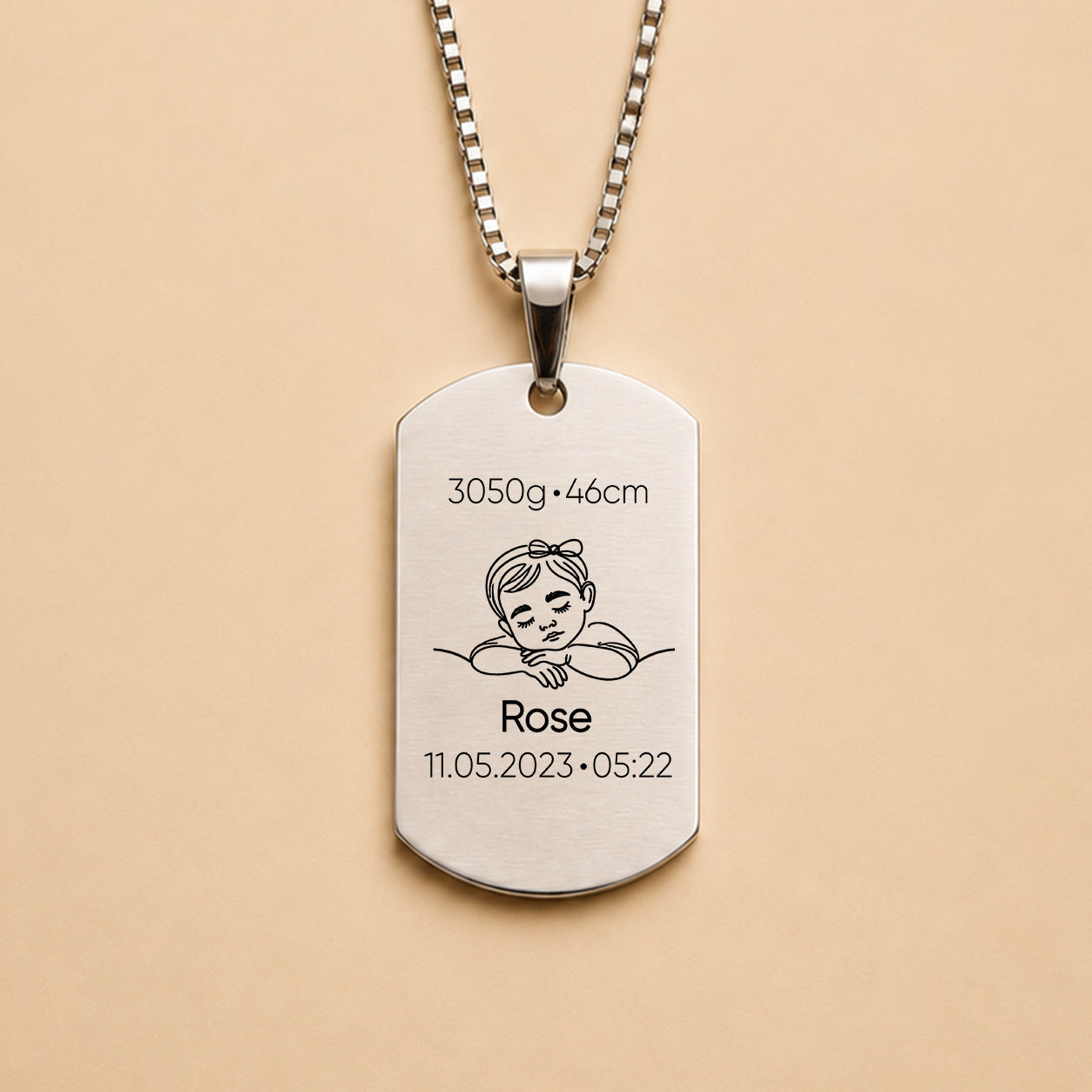 Silver personalised baby keepsake necklace worn on model, engraved with baby name Violet, birth weight, height, date and time.