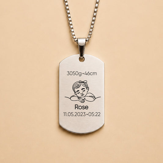 Silver personalised baby keepsake necklace worn on model, engraved with baby name Violet, birth weight, height, date and time.