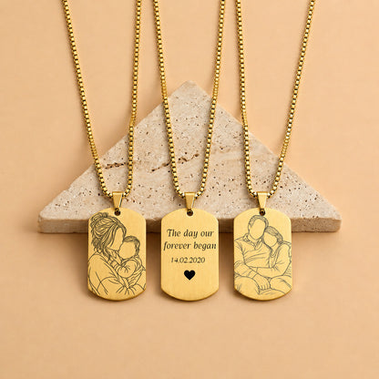 Man wearing a gold AMARA outline necklace with a mother and baby line art portrait engraving

